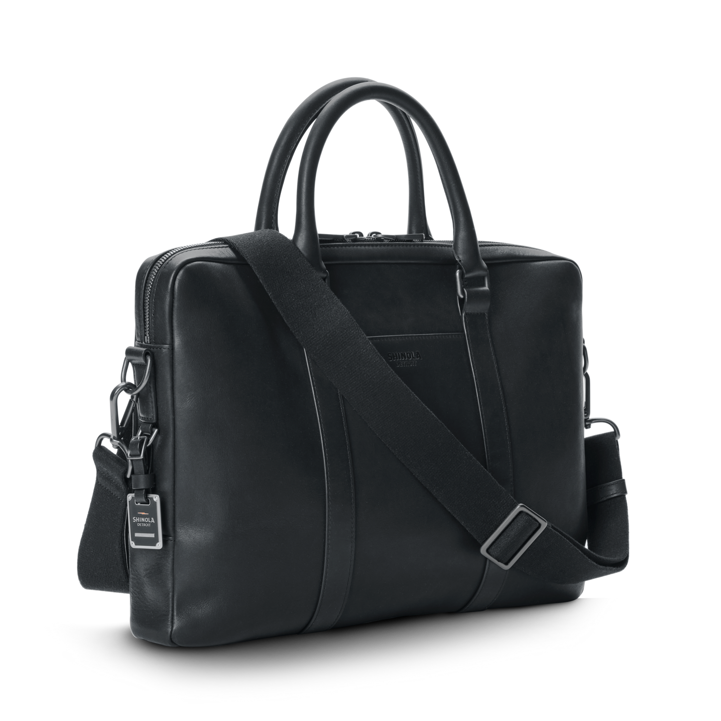 The nicelaundry-jp.computer Briefcase - Black features double handles, a detachable shoulder strap, silver hardware, and a small branded tag, all in sleek black leather, shown against a plain white background.