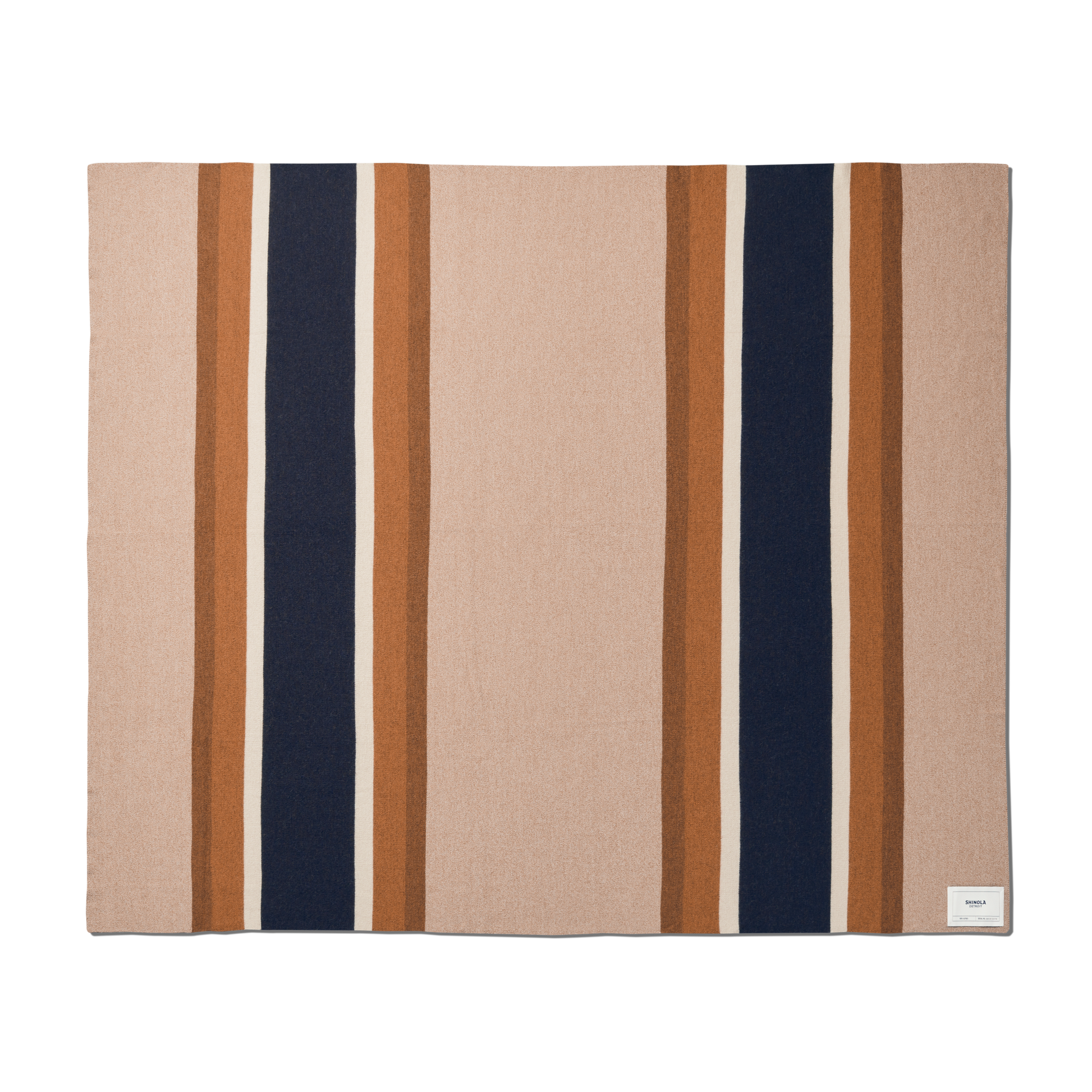 The Shinola Alpaca Throw Blanket in Pink/Beige features a rectangular design with a soft color palette and a small white corner label. Crafted from sustainable alpaca fiber for lightweight warmth and comfort.