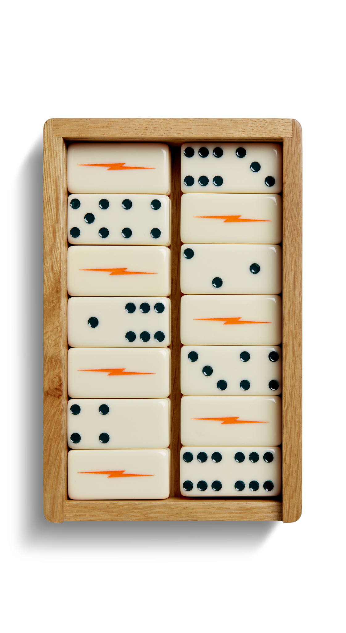 The Shinola Dominoes Set - Cream / Blue features twelve hand-painted dominoes with black dots and orange lightning bolts, arranged in three rows of four in a wooden box, shown from above on a white background.