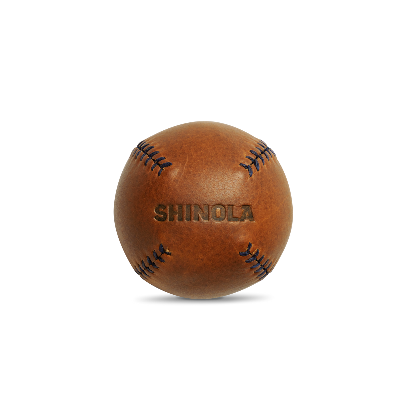 A brown premium leather baseball with visible stitching and "Shinola" embossed, the Leather Baseball - Bourbon / Navy exemplifies Shinola’s expert craftsmanship, set against a clean white background.