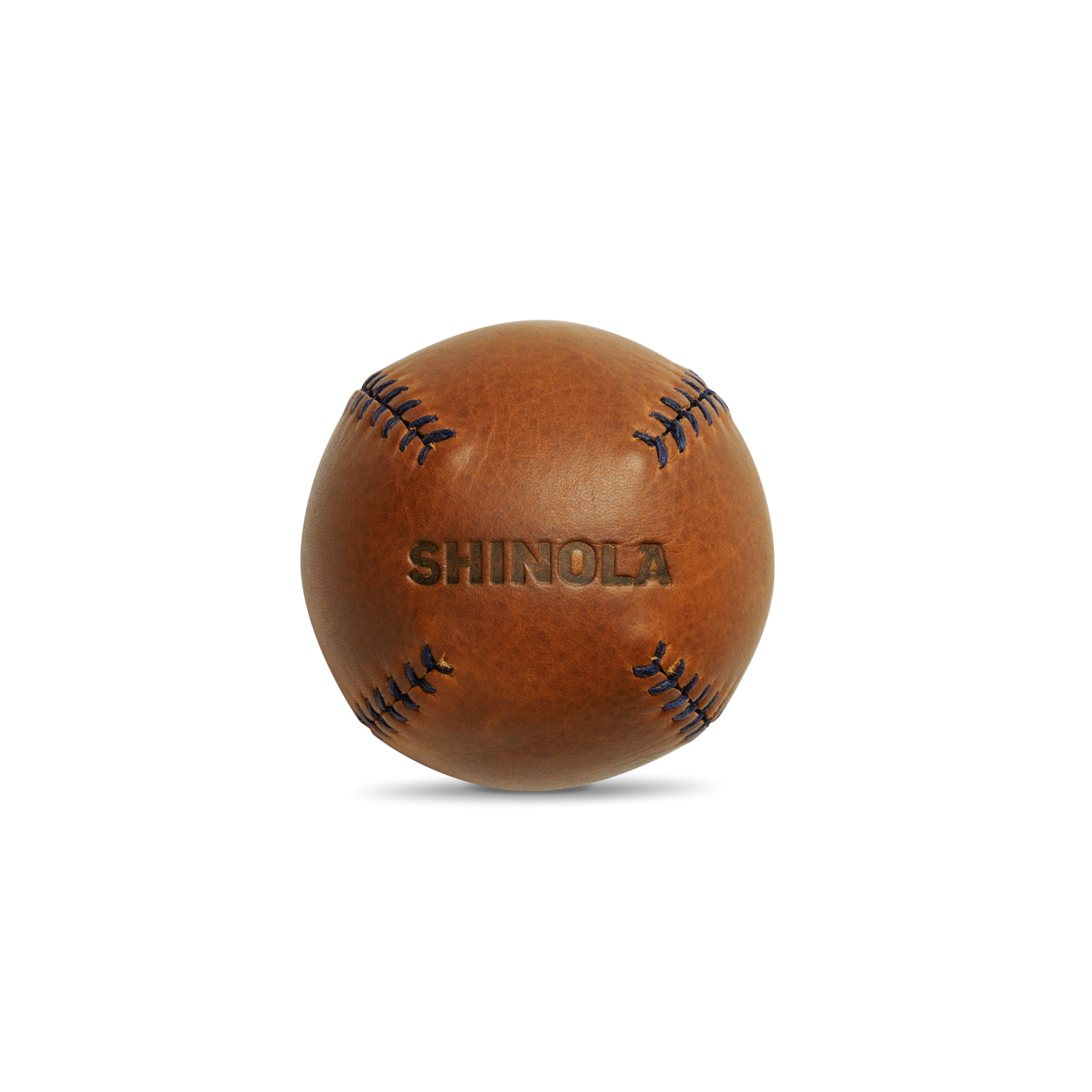 A brown premium leather baseball with visible stitching and "Shinola" embossed, the Leather Baseball - Bourbon / Navy exemplifies Shinola’s expert craftsmanship, set against a clean white background.