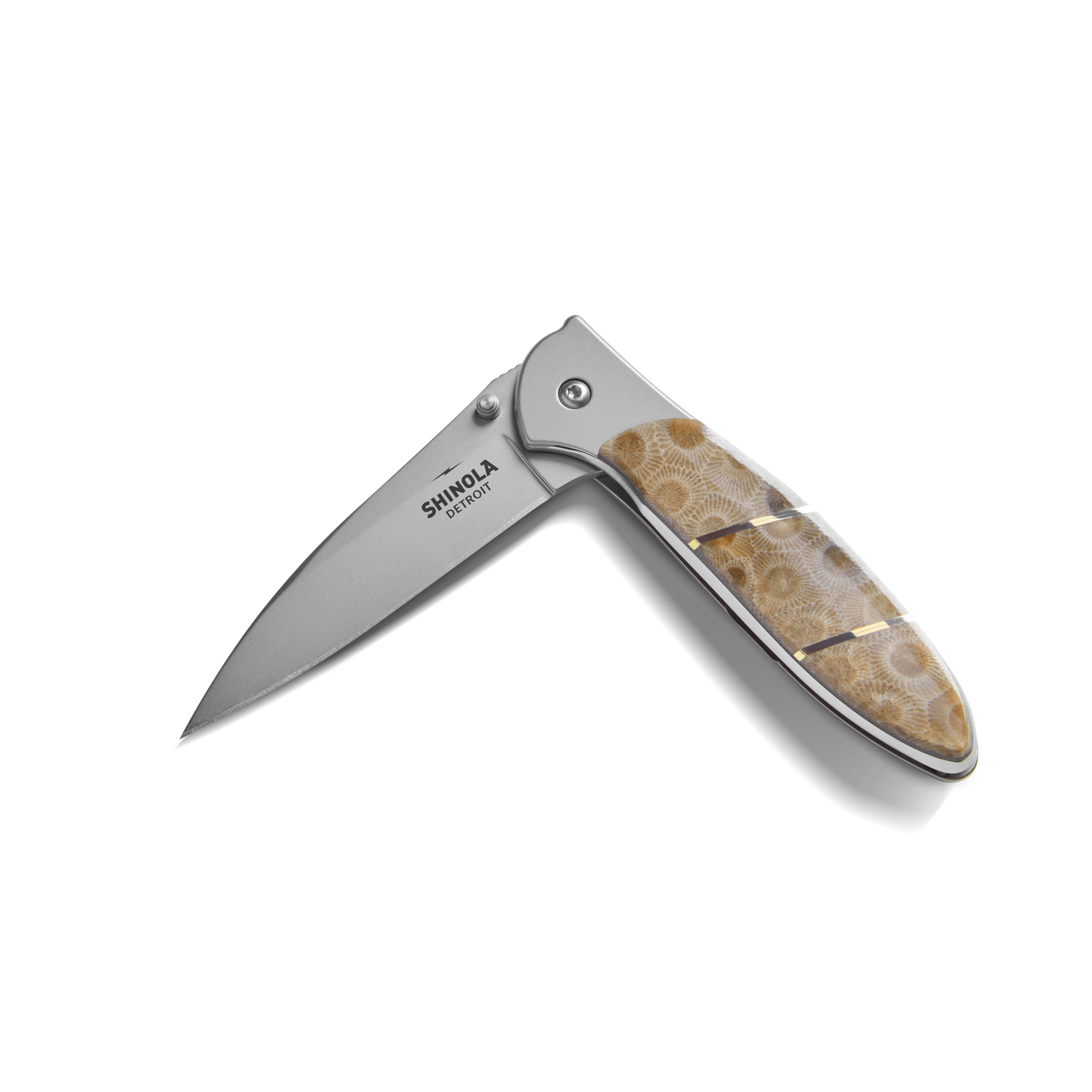 The Shinola + Kershaw Petoskey Stone Pocket Knife features a polished, textured brown Petoskey Stone handle and partially open silver blade with "Shinola" branding.